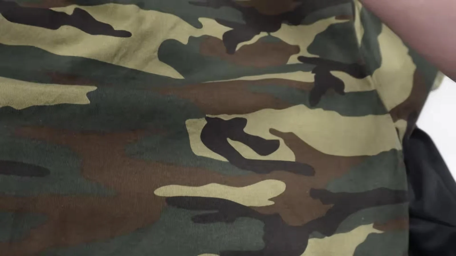 Close view of camo shirt fabric during AMS DTF powder test